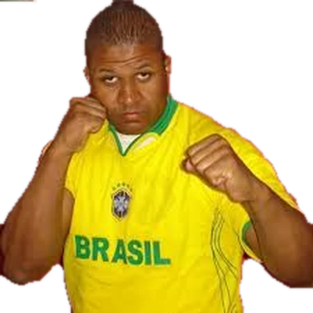 Coach Andre Miguel in a Brazil jersey, fists up in a boxing guard