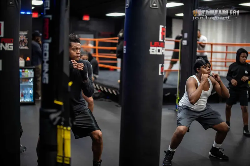 Teen boxers working between the heavy bags