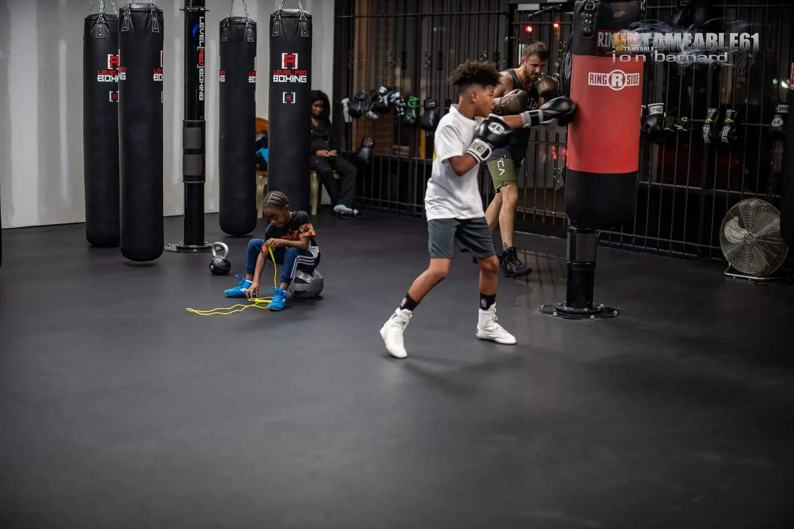 A young boxer working the heavy bag row